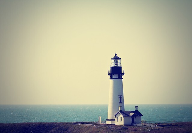 A lighthouse in the fog done with a retro vintage instagram filter